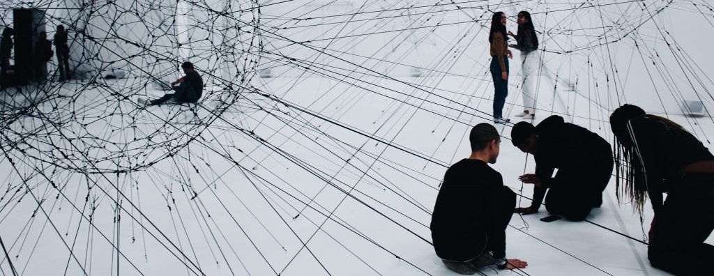 A photograph of Algo-r(h)i(y)thms - an interactive installation by contemporary visual artist Tomàs Saraceno. 